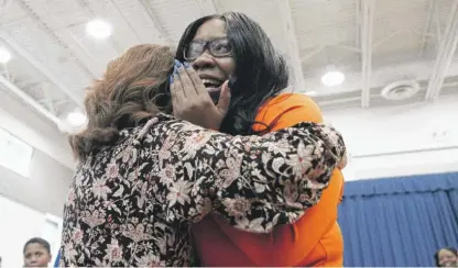  ?? PAT NABONG/SUN-TIMES ?? Comfort Agboola (right), a teacher at the Edgar Allan Poe Classical Elementary School in the Pullman neighborho­od, cries as she finds out she won the Milken Educator Award on Friday.