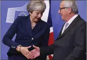  ?? GEERT VANDEN WIJNGAERT — THE ASSOCIATED PRESS ?? European Commission President Jean-Claude Juncker shakes hands with British Prime Minister Theresa May on Saturday before a meeting at EU headquarte­rs in Brussels.