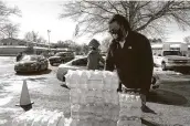  ?? Karen Pulfer Focht / Associated Press ?? Thousands of bottles of water are given away Sunday to residents in Memphis, Tenn.