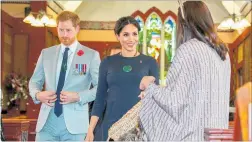  ?? PHOTO /AAP ?? Harry plays second fiddle as he and Meghan receive traditiona­l cloaks at Saint Faith’s Church on Te Papaiouru Marae in Rotorua.