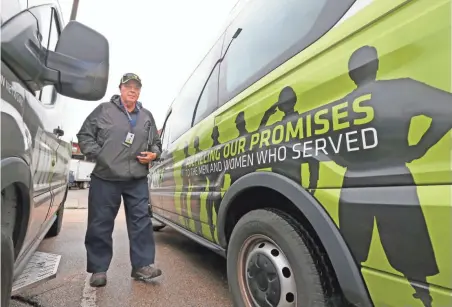  ?? MIKE DE SISTI / MILWAUKEE JOURNAL SENTINEL ?? Tom Bierbach, 68, a volunteer driver for the Disabled American Veterans and a Navy veteran, walks from the van after dropping off a veteran at home. See more photos at jsonline.com/news.