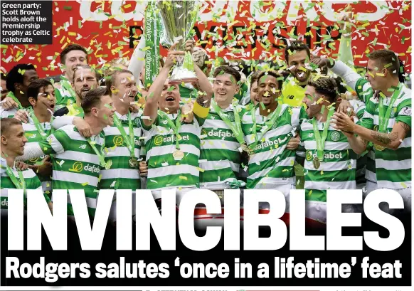  ??  ?? Green party: Scott Brown holds aloft the Premiershi­p trophy as Celtic celebrate