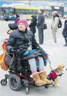  ?? GERRY KAHRMANN ?? Josee Menard, pictured with her dog Toby, says she would welcome ridesharin­g services like Uber. “I think as long as everybody makes it safe, it just becomes another taxi company, basically,” she said.