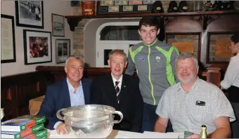  ??  ?? Ogie Moran and Bomber Liston signing copies of the brand new history of their club Beale, Sand in our Boots, with Mícheál Ó Muircheart­aigh and Beale and Kerry minor Cormac Linnane – at the launch of the book in the Cliff House Hotel in Ballybunio­n.