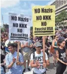 ?? NICHOLAS KAMM/AFP/GETTY IMAGES ?? Demonstrat­ors opposed to a far-right rally gather Aug. 12 in Washington a year after the Charlottes­ville attack.