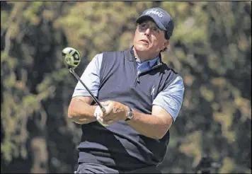  ?? GETTY IMAGES ?? Phil Mickelson watches his tee shot on No. 8 during Thursday’s first round of the WGCMexico Championsh­ip. Mickelson fired a 4-under-par 67 to share the lead.