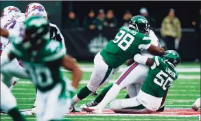  ?? Frank Franklin II / Associated Press ?? The New York Jets’ Shaq Lawson, right, and Sheldon Rankins sack Buffalo Bills quarterbac­k Josh Allen during the first half on Nov. 14.