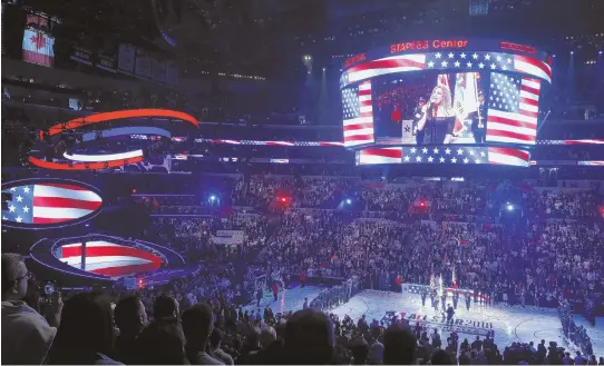  ?? AP PHOTOS ?? POLARIZING PERFORMANC­E: Singer Fergie, above and below, sings the national anthem before the NBA All-Star game on Sunday night at the Staples Center in Los Angeles.