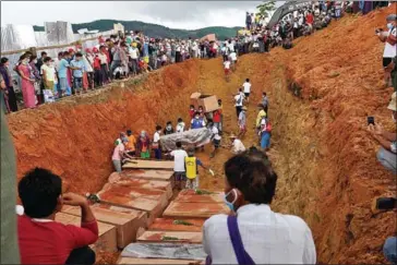  ?? AFP ?? Dozens of jade miners were buried on Friday in a mass grave after a landslide in northern Myanmar killed over 170.