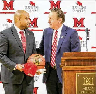  ?? GREG LYNCH / STAFF ?? Miami Athletic Director David Sayler introduces Jack Owens (left) as basketball coach in March. Since then, Owens has added four freshmen and a junior college transfer to rebuild the roster.