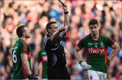  ?? Photo by Sportsfile ?? Lee Keegan of Mayo, right, is shown a black card by referee Maurice Deegan during the All-Ireland SFC Final replay between Dublin and Mayo at Croke Park.