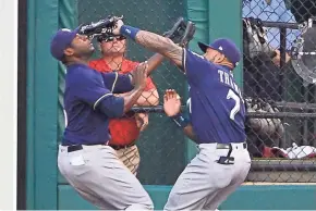  ?? GETTY IMAGES ?? Eric Thames collides with Lorenzo Cain after making a catch during the first inning. Thames left the game in the third with a sore left knee.