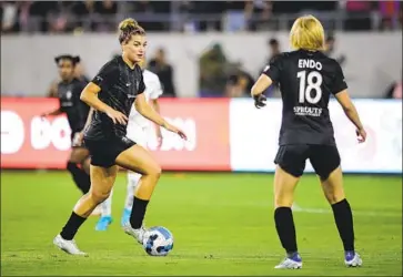  ?? Meg Oliphant Getty Images ?? CARI ROCCARO, left, of Angel City FC looks to pass as teammate and Japanese national team member Jun Endo looks on. Endo scored Angel City’s second goal in the 2-1 victory over the North Carolina Courage.