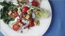  ?? THE ASSOCIATED PRESS ?? Discover the joys of grilled lettuce with this grilled BLT salad with buttermilk dressing.