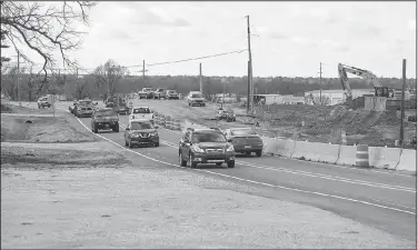  ?? NWA Democrat-Gazette/BEN GOFF • @NWABENGOFF ?? Cars pass by road constructi­on Thursday on Arkansas 265/Old Wire Road near the intersecti­on with East Randall Wobbe Lane in Springdale.