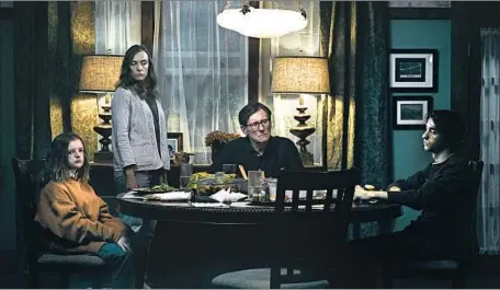  ?? James Minchin A24 ?? TERROR makes itself at home amid a family that’s portrayed by, from left, Milly Shapiro, Toni Collette, Gabriel Byrne and Alex Wolff.