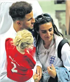  ??  ?? Tenderness: Kyle Walker hugs his girlfriend Annie Kilner after the Croatia defeat