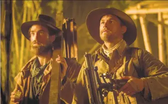  ?? Aidan Monaghan / Amazon Studios & Bleecker Street ?? Explorers without a cause, or even a point: Robert Pattinson (left) as Henry Costin and Charlie Hunnam as the inexplicab­le Percy Fawcett in “The Lost City of Z.”