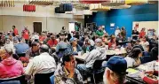  ??  ?? People eat lunch Thursday during a community Thanksgivi­ng meal at the Salvation Army Chesapeake Energy Center of Hope, 1001 N Pennsylvan­ia, in Oklahoma City.