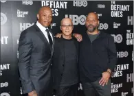  ?? PHOTO BY EVAN AGOSTINI/INVISION/AP, FILE ?? In this June 27 photo, music mogul Jimmy Iovine, center, poses with rapper Dr. Dre, left, and producer Allen Hughes at the premiere of HBO's "The Defiant Ones" at the Time Warner Center in New York.