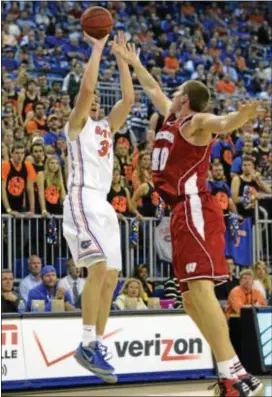  ?? Associated Press ?? Florida’s Erik Murphy shoots a 3- pointer over Wisconsin’s Jared Berggren during the first half of Wednesday’s game.