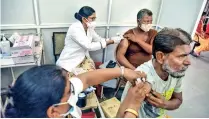  ??  ?? Health workers administer COVID-19 vaccine to a person at a special vaccinatio­n camp in Bikaner