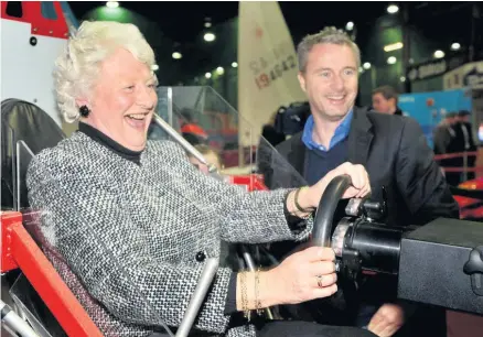  ?? AARON MCCRACKEN ?? Sporting heroes: Olympic Gold Medallist Lady Mary Peters gets a lesson on the Formula One simulator from Eddie Irivine at an event to promote the Ulster Sports Museum in Bangor in 2010