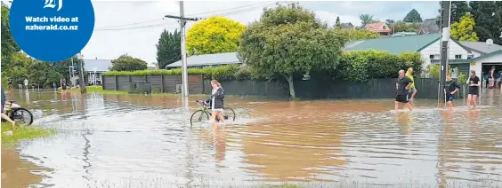  ?? Photo / Hamilton News ?? Watch video at nzherald.co.nz Firefighte­rs said 24 residents were evacuated from 10 homes on or near Whatawhata Rd in Hamilton yesterday after the flash flooding.