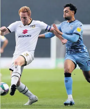  ??  ?? Coventry City goalscorer Tyler Walker in action with MK Dons’ Dean Lewington