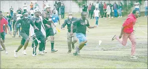  ?? ?? Mbabane Highlander­s’ supporters give chase to an alleged Vovovo FC fan on Sunday at the Prince of Wales Sports Ground during the MTN Premier League. The fan was assualted before he was whisked away to safety.