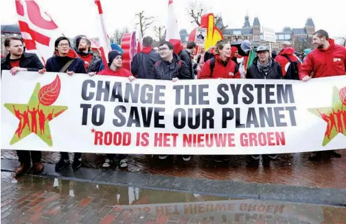 ?? Reuters ?? People take part in a protest to combat climate change in central Amsterdam, Netherland­s, on Sunday.