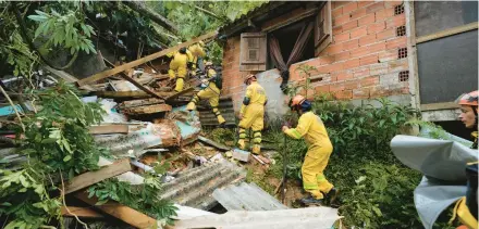  ?? ANDRE PENNER/AP ?? Rescue workers search for survivors Monday after flooding triggered deadly landslides near Juquehy beach in Sao Sebastiao, Brazil. Nearly 800 people are homeless.