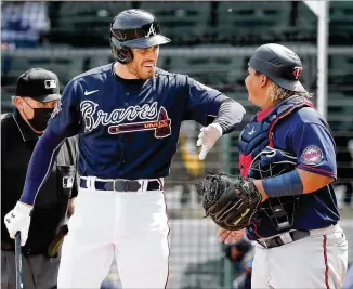  ?? CURTIS COMPTON/CURTIS.COMPTON@AJC.COM ?? Braves first baseman Freddie Freeman greets Twins catcher Williams Astudillo as he makes his first at-bat of spring at Cooltoday Park on Friday. Freeman was particular­ly satisfied with his first plate appearance, when he said the ball left his bat at around 107 mph.