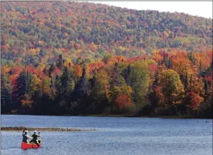  ??  ?? In this Sept. 27, 2014, file photo, Brad and Sue Wyman paddle their 1930s Old Town Guide canoe along the Androscogg­in River as leaves display their fall colors north of the White Mountains in Dummer, N.H. AP PHOTO/JIM COLE