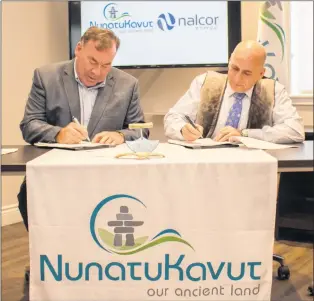  ?? SUBMITTED PHOTO ?? Nalcor Energy CEO Stan Marshall (left) and Nunatukavu­t Community Council president Todd Russell sign a community developmen­t agreement on Monday.