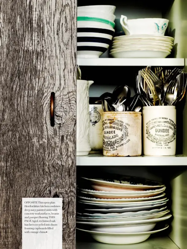  ??  ?? OPPOSITE This open-plan Herefordsh­ire kitchen combines deep navy painted units with concrete worksurfac­es, beams and parquet flooring THIS PAGE Aged, reclaimed oak has been recycled into doors fronting cupboards filled with vintage china