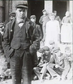  ??  ?? London boy It wasn’t just in Birmingham that image-conscious young men turned to gangland life, as this photograph of a hooligan and friends in the capital from c1900 shows