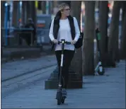  ?? NHAT V. MEYER — BANG ARCHIVES ?? A woman rides a Bird rental scooter in downtown San Jose recently.