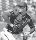  ?? PHOTOS BY ROB SCHUMACHER/THE REPUBLIC ?? Diamondbac­ks pitcher Tommy Henry throws in a spring training game against the Rangers on Wednesday.