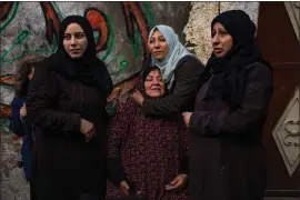  ?? FATIMA SHBAIR — THE ASSOCIATED PRESS ?? Palestinia­n women react after their home was hit by an Israeli strike in Rafah, southern Gaza Strip, on Thursday.