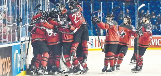  ?? PRESSFOCUS/MB MEDIA GETTY IMAGES ?? Team Canada celebrates Mark Stone’s overtime goal to advance to face the Czech Republic in the semifinals of the world hockey championsh­ip.