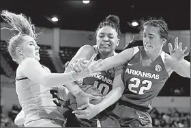  ?? AP/ROGELIO V. SOLIS ?? Mississipp­i State forward Chloe Bibby (left) fights for a rebound with Arkansas forward Kiara Williams (10) and guard Bailey Zimmerman (22) during the first half Thursday in Starkville, Miss. Mississipp­i State won 111-69.