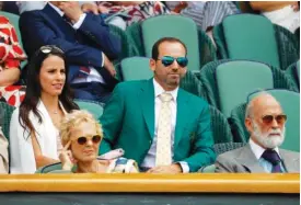  ?? ASSOCIATED PRESS FILE PHOTOS ?? Golfer Sergio Garcia, wearing his green Masters jacket, and fiancée Angela Akins sit in the Royal Box last Friday at Wimbledon.