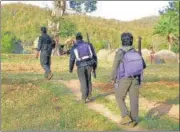  ?? HT FILE ?? Cpi(maoists) cadres crossing a field in Chhattisga­rh.