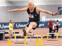  ??  ?? Professor Bill Jankovich clears a hurdle in the 60-meter hurdles event of the men’s 80 age division at the USA Track and Field Indoor Championsh­ips at the Convention Center.