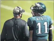  ?? DERIK HAMILTON — THE ASSOCIATED PRESS ?? Eagles QB Carson Wentz, right, and head coach Doug Pederson talk during the first half Sunday against the Ravens.