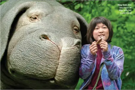  ??  ?? Hog-tied: Ahn Seo-Hyun as Mija with her
giant friend