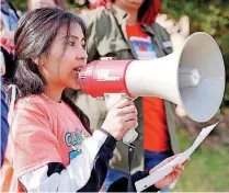  ??  ?? Dunia Dominguez, a junior, speaks Thursday as immigrant youth and students at Santa Fe South High School stage a walkout and rally.