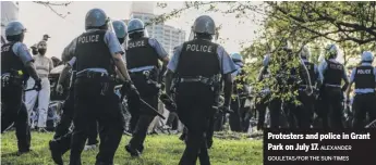  ?? ALEXANDER GOULETAS/ FOR THE SUN- TIMES ?? Protesters and police in Grant Park on July 17.