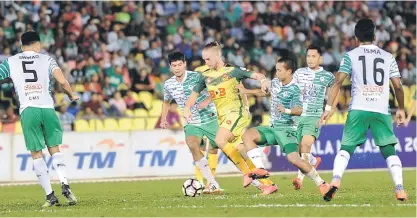  ??  ?? Kedah’s Ken Ilso Larsen is the focus of Malacca’s defence. — Bernama photo